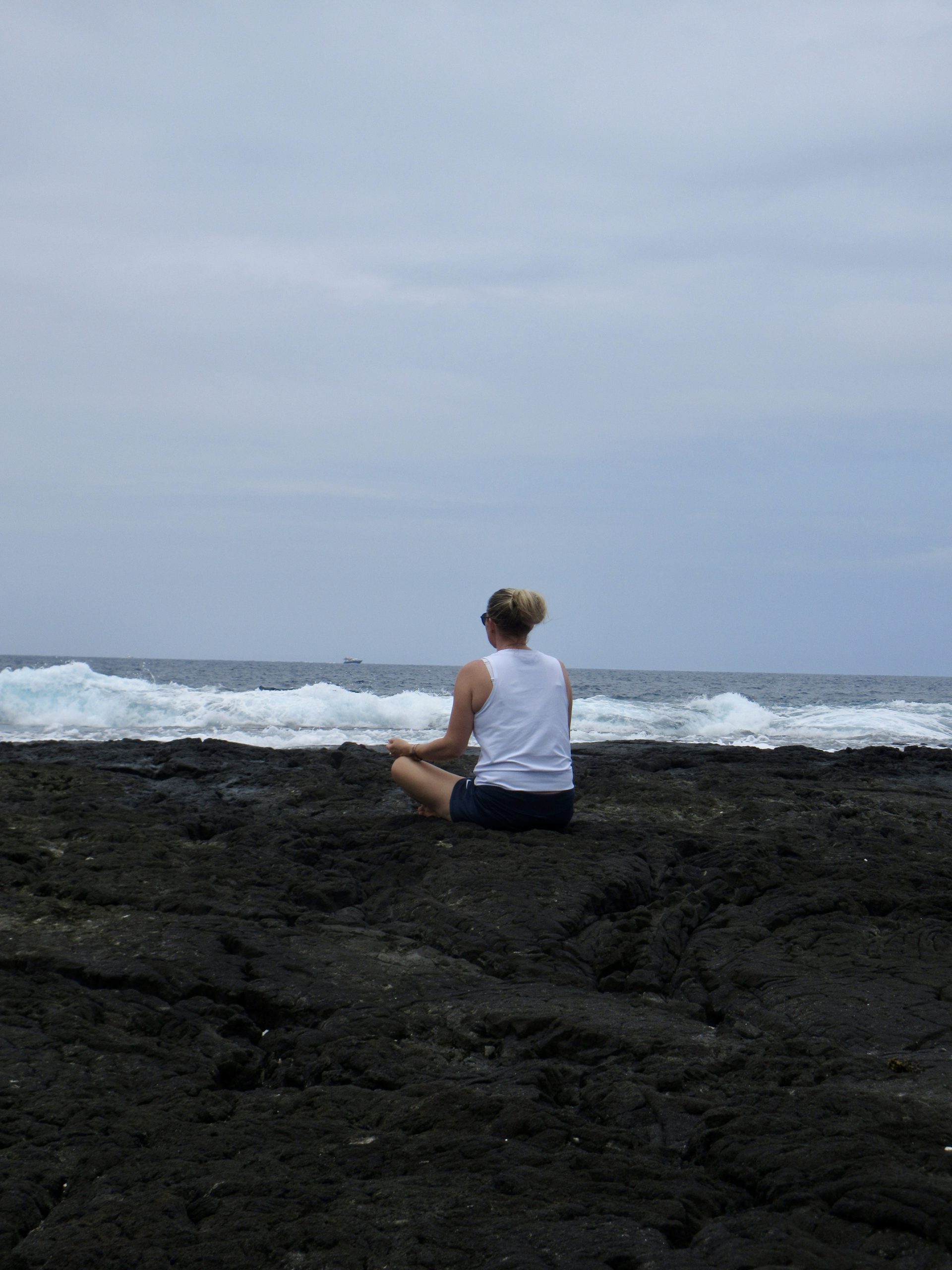 A woman meditating quietly in nature at an Align women's wellness retreat